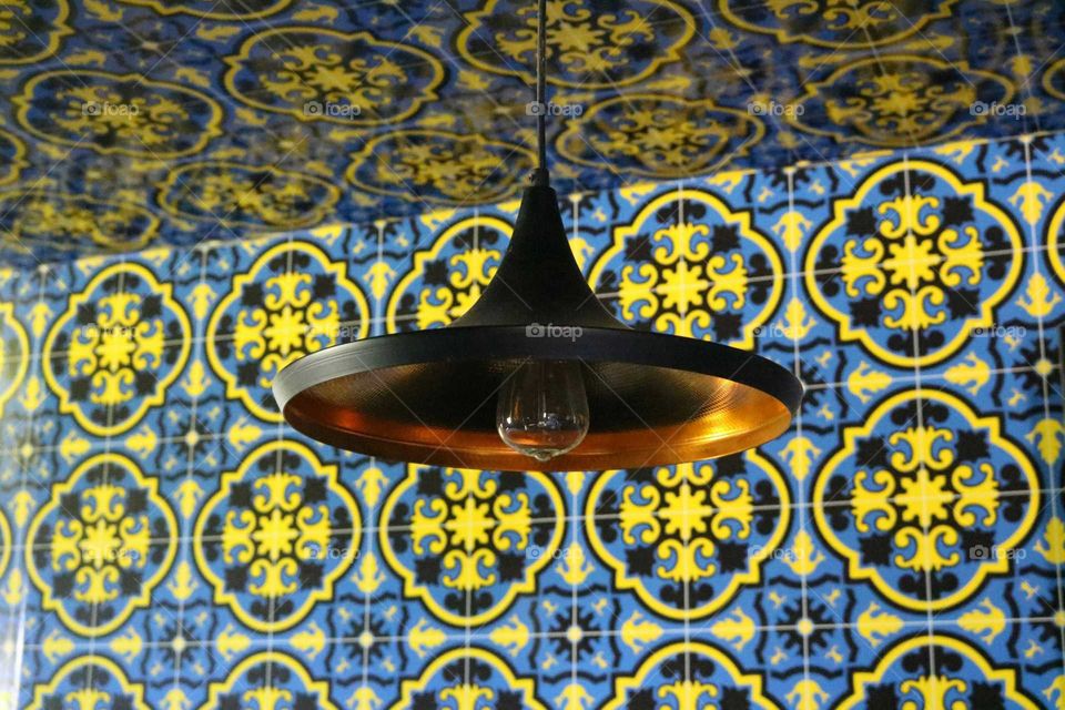 Lamp and wall of tiles