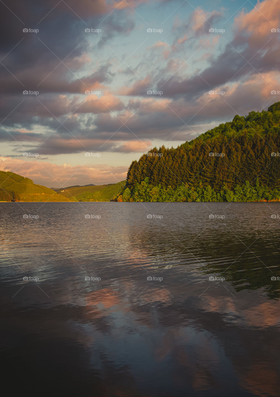 Scenic view of lake against sky during sunset.