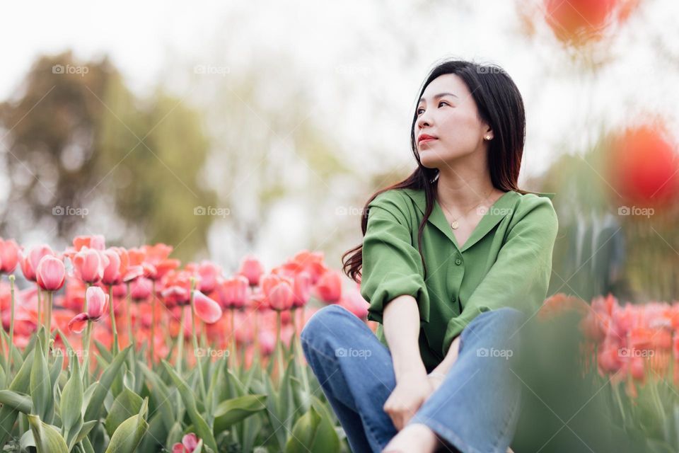 Beautiful woman on tulips field 