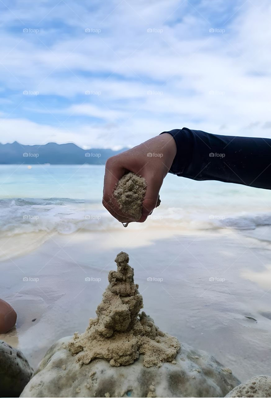 child playing sand on the beach
