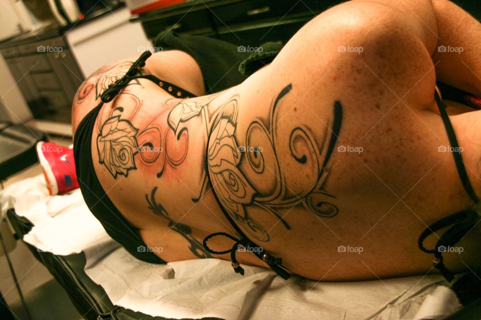 Rose tattoo on a woman's back