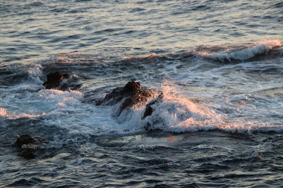 View of the wavy rocky atlantic ocean at sunrise 