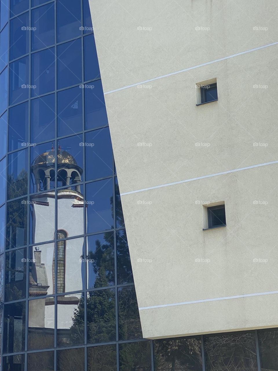 Reflection of church in the window of building 