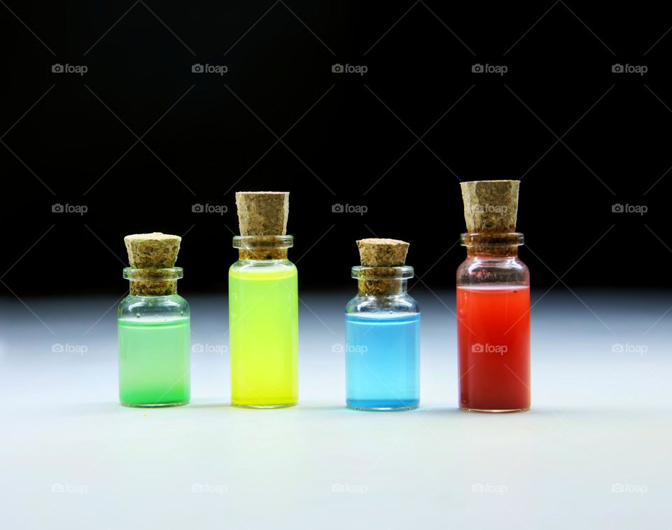 bottles with colored liquid on the table