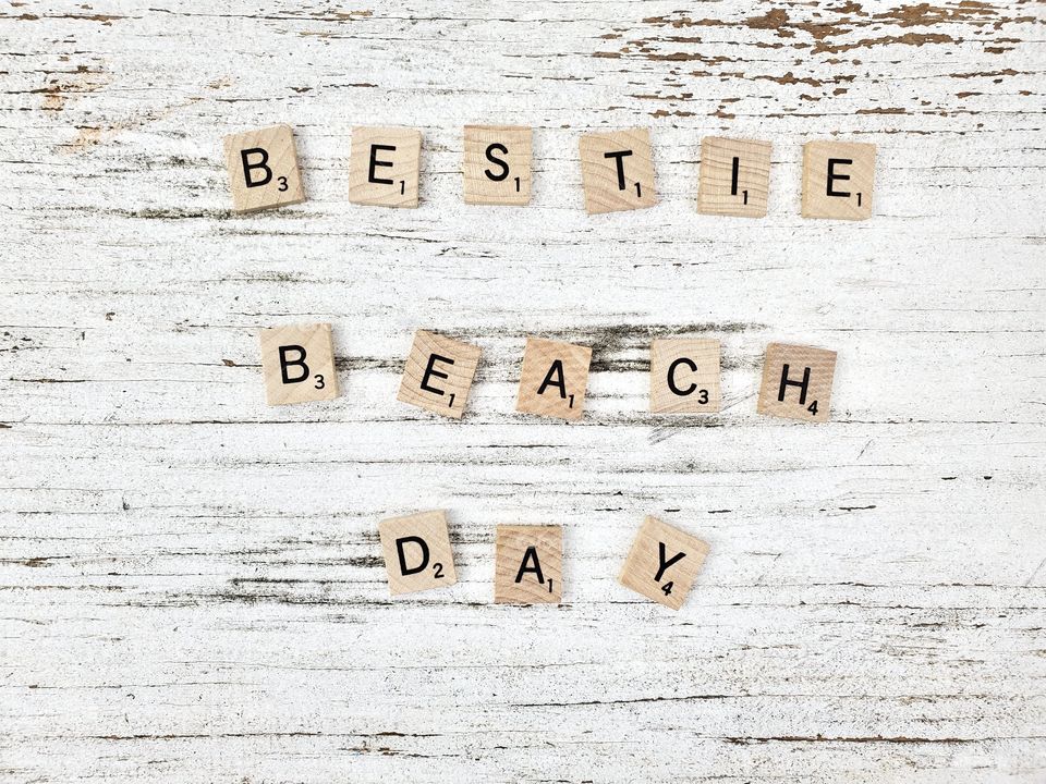 Best friends beach day wooden square word tiles on a rustic white background 