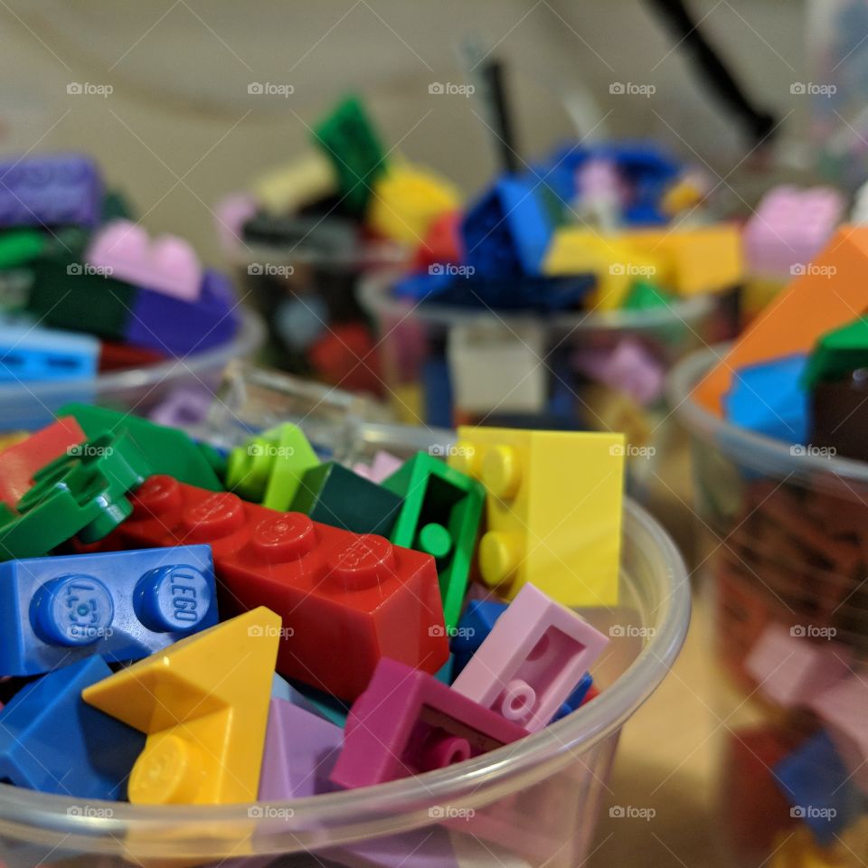 Cups of LEGO ready for use in a training session on goal setting with a wide variety of brightly coloured lego pieces.

Participants can use this LEGO to create a variety of objects.