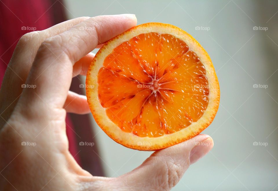 sliced orange fruit in the hand healthy living