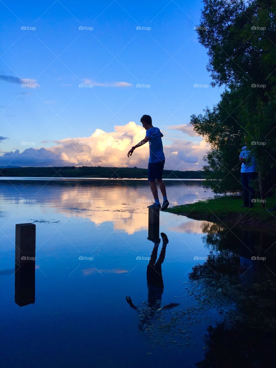 The stunning reflection of my brother and surrounding scenery on the waters of Roadford Lake.