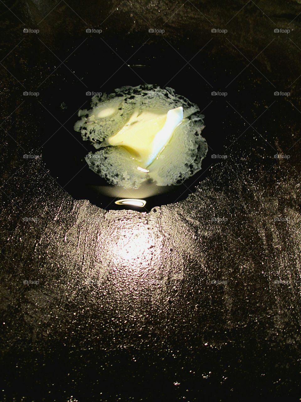 Butter melting on a frying pan