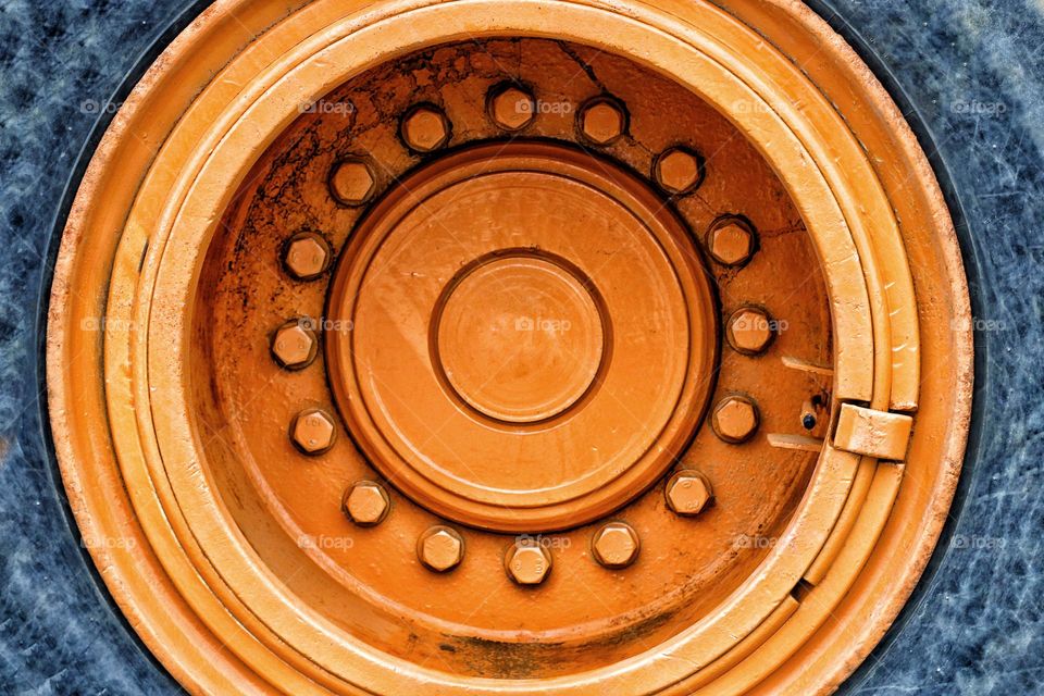 Close-up of an orange wheel bearing and tire of a truck