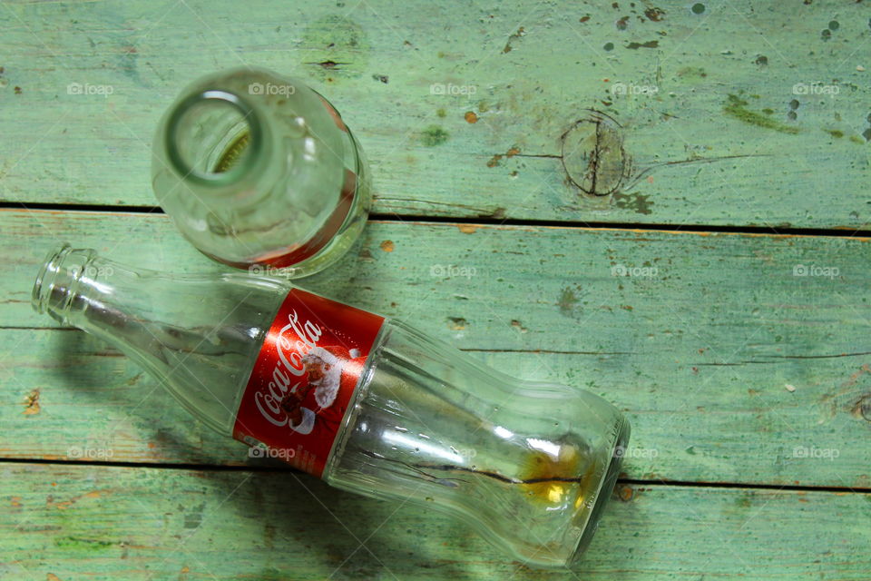 bottles of Coca cola on a wooden table