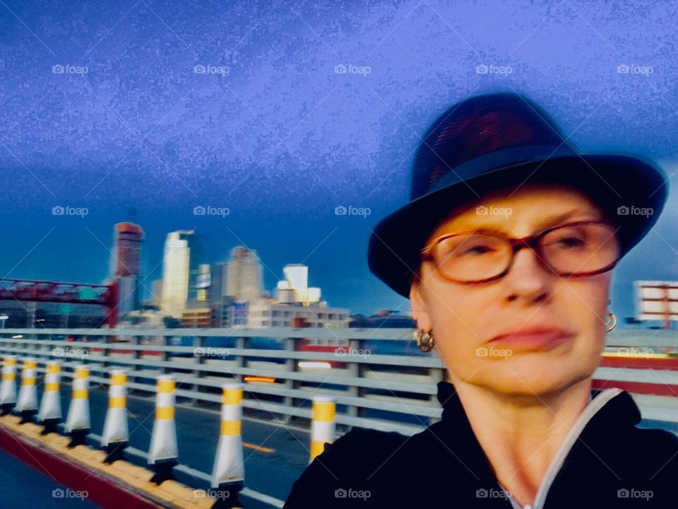 A self portrait set against the backdrop of the fenced off car lanes leading across the Pulaski Bridge from LIC, Queens to Greenpoint, Bklyn, NY photographed in the Spring of 2019. Hypnotic Productions