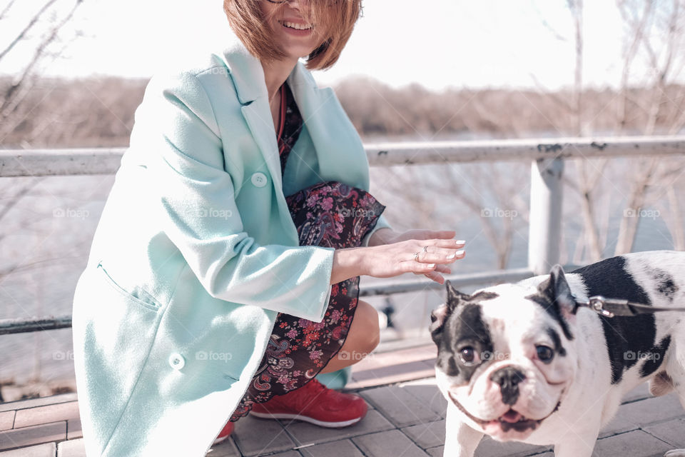 Smiling girl walking with dog