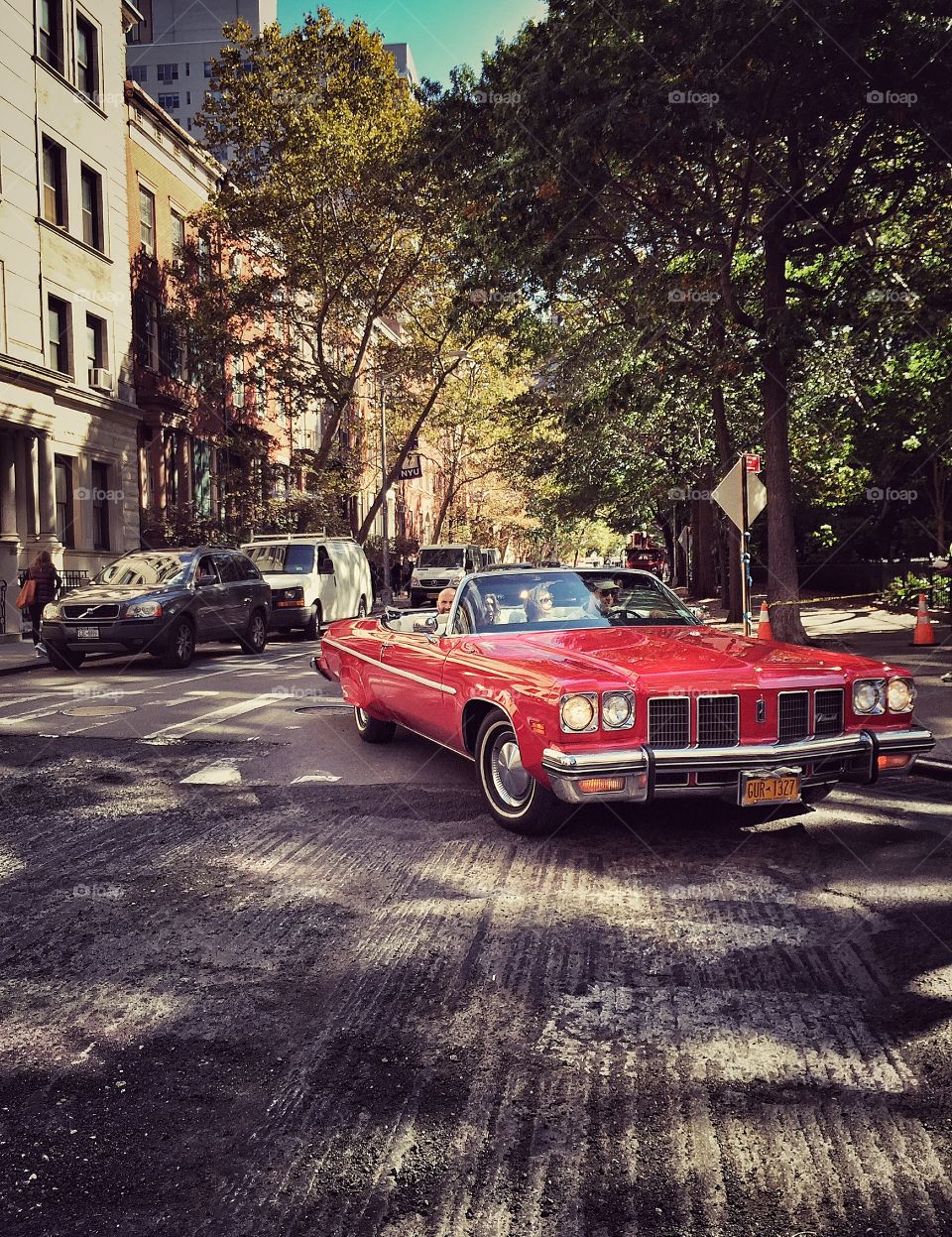 Red old fashioned car on the streets of New York