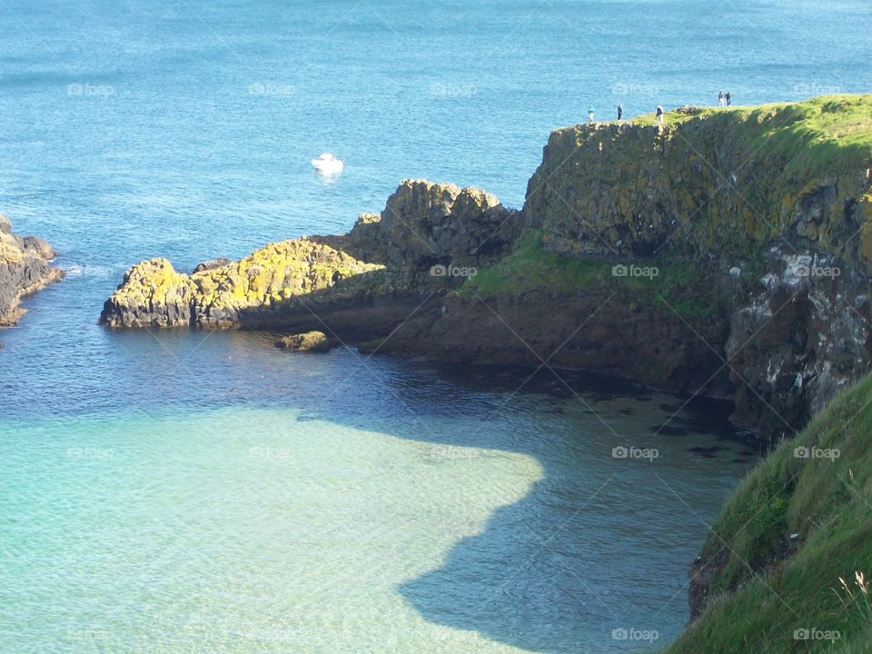 Cliffs, water, and tourists at Carrick-a-rede