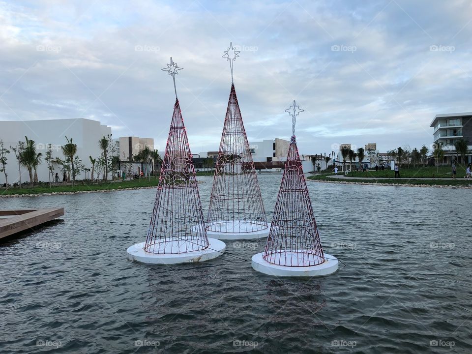 TRS Coral hotel resort in Cancun, Mexico. Floating Christmas trees in daylight. 