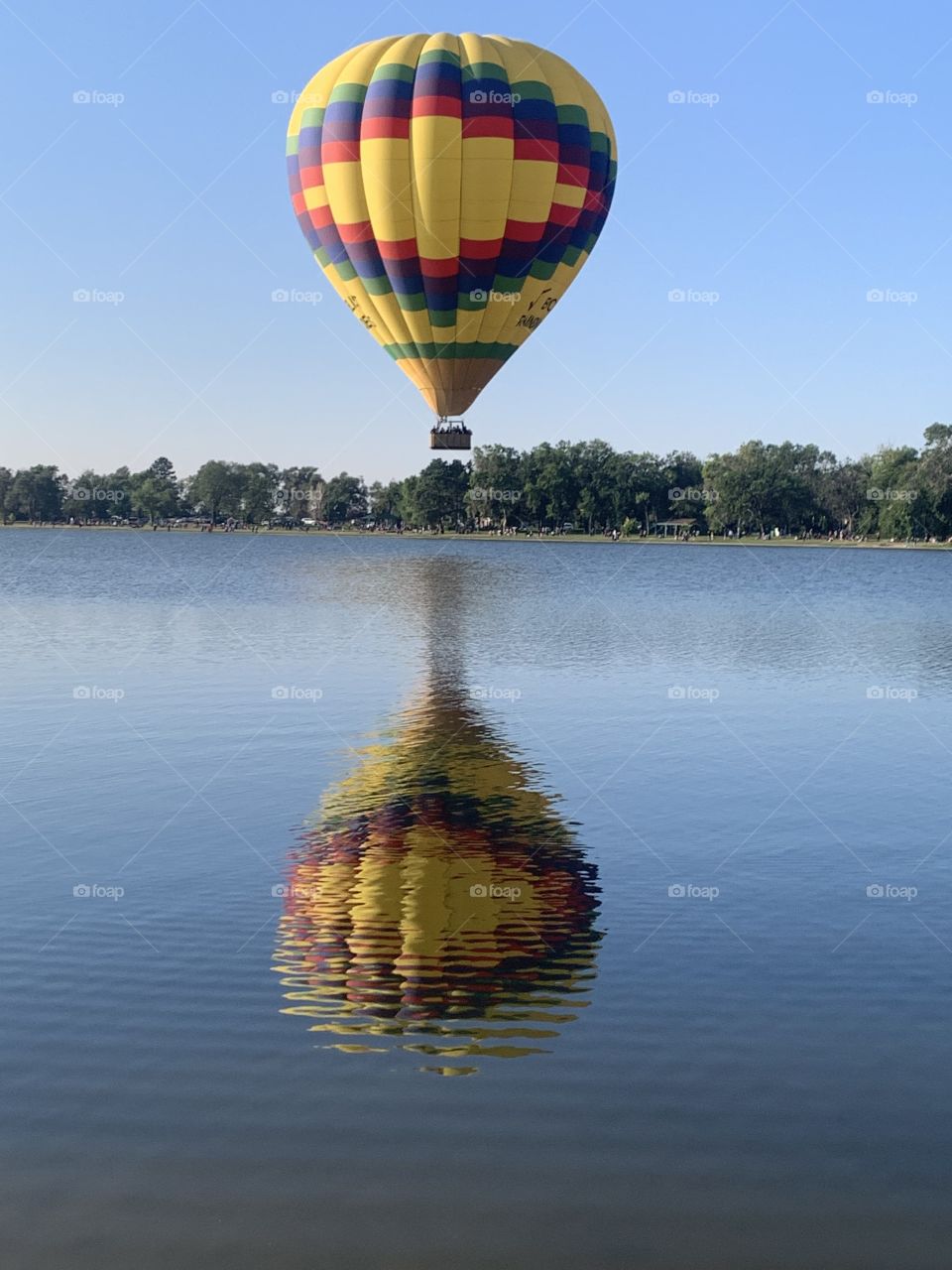 Colorado Springs Balloon Festival. Balloon reflection over lake