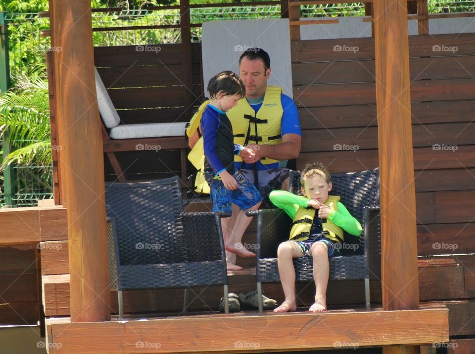 Dad Teaching Sons To Swim