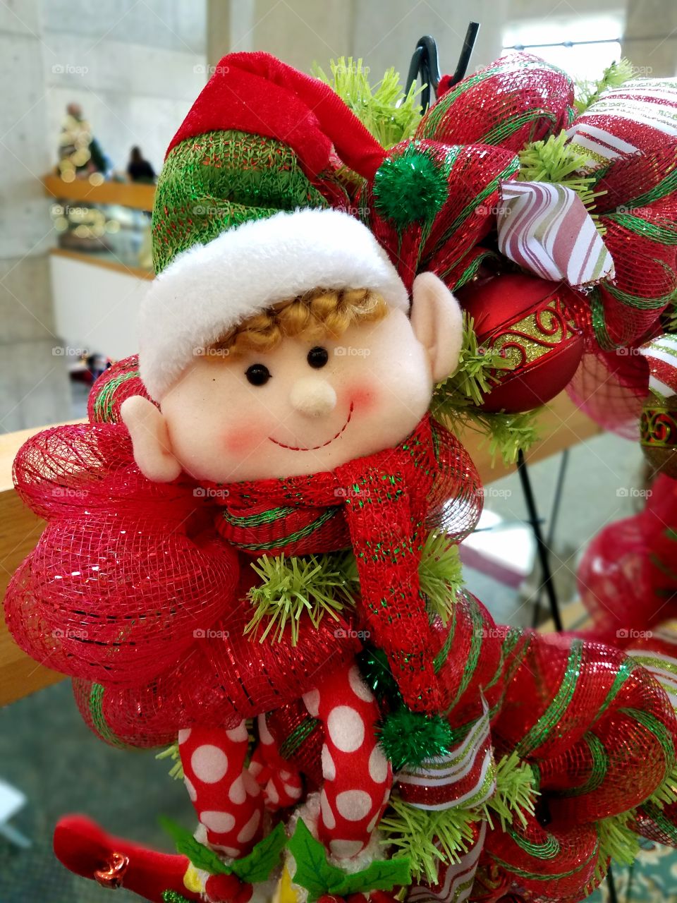 Tiny elf decorated on a Christmas wreath