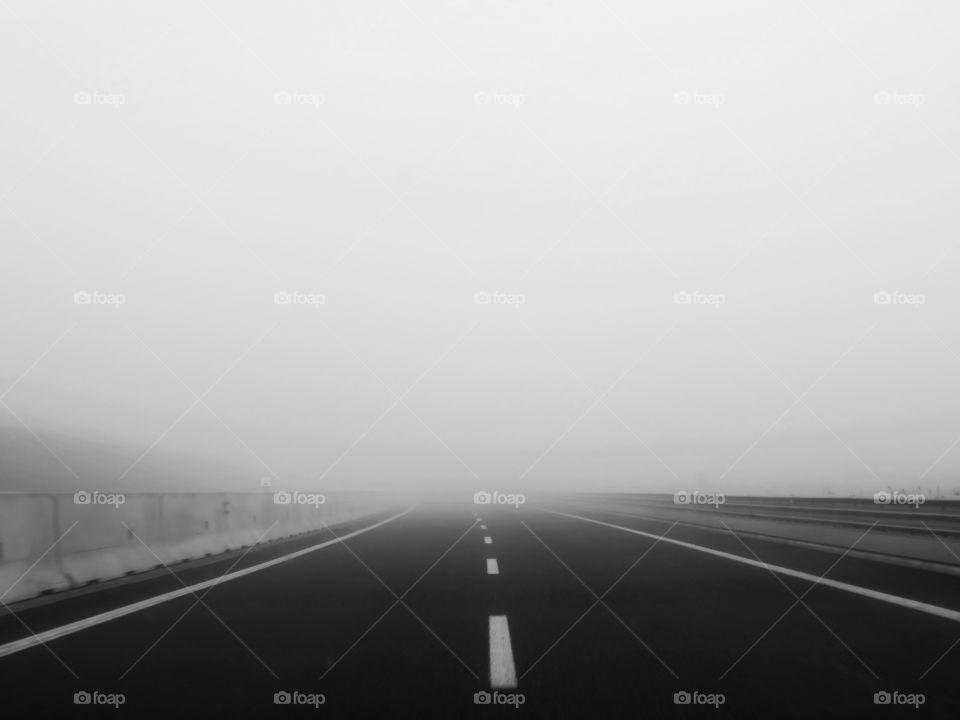 alone in the foggy road