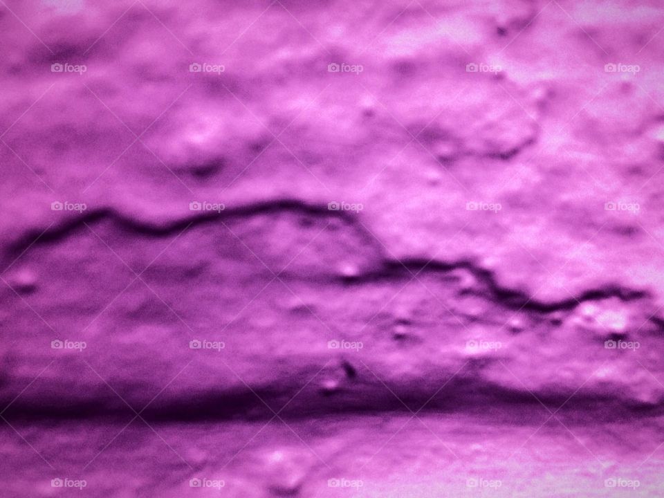 Purple paint on rough concrete