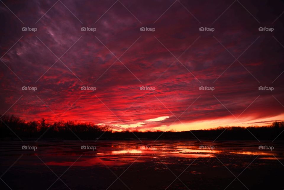 Fire and ice. Got a good sunset On a unusually warm day and the ice was melting giving me a nice reflection