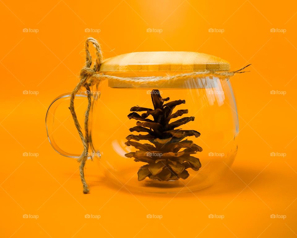 a glass with pinecone