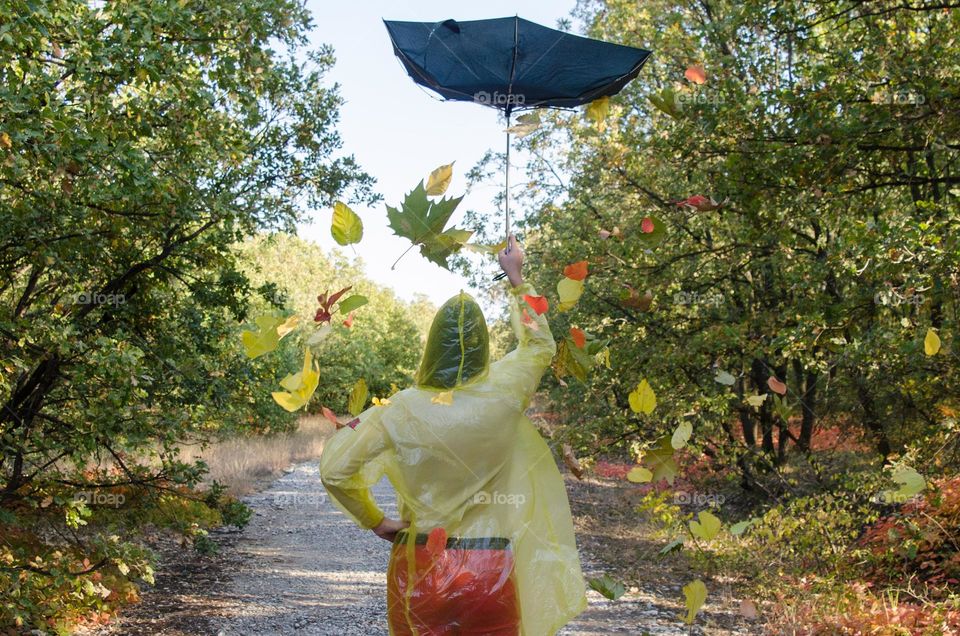 Young Girl with Umbrella on Autumn background