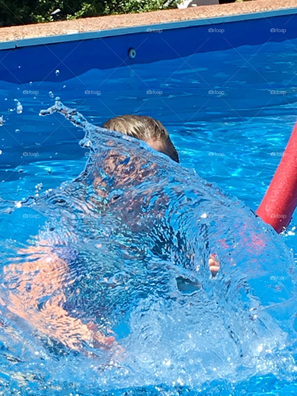 Splashing water in outdoor swimming pool