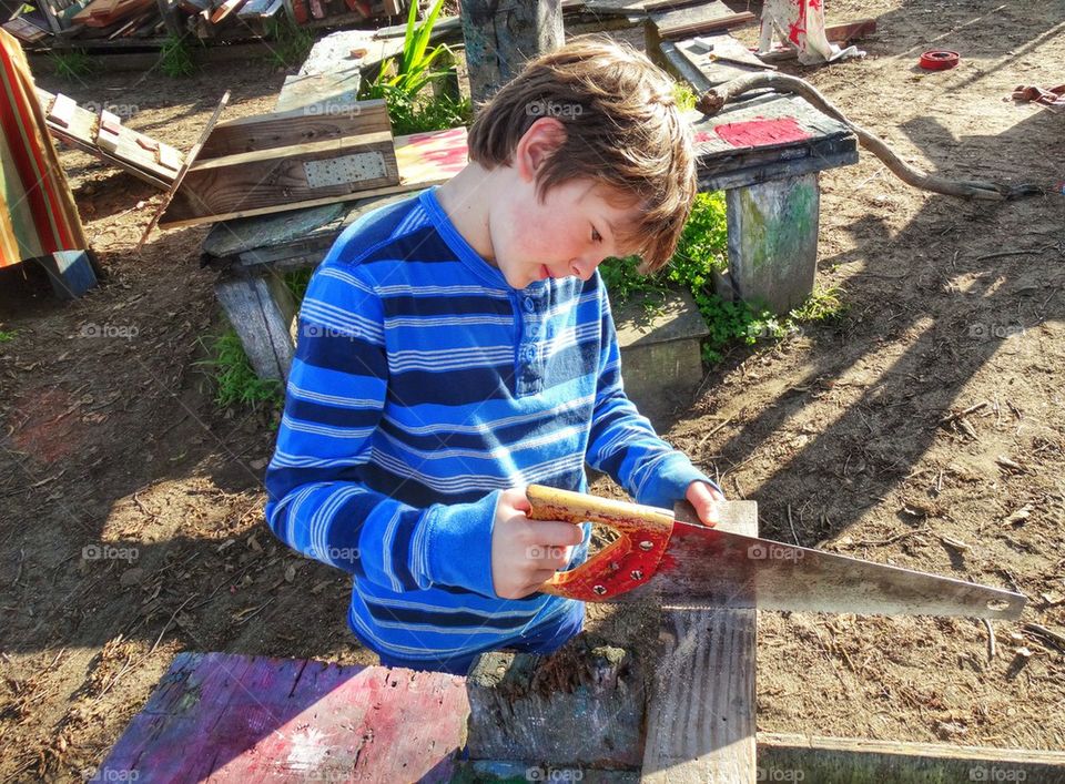 Young Man Learning Carpentry. Boy Practicing Woodworking Skills
