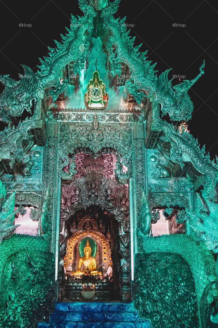 The incredibly ornate Silver Temple lit up at night in Chiang Mai, Thailand 