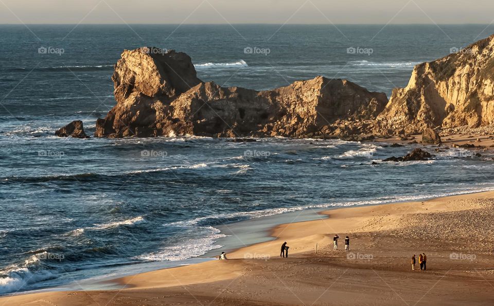 A view of cliffs jutting out into the Atlantic Ocean at Pataias, just before sunset