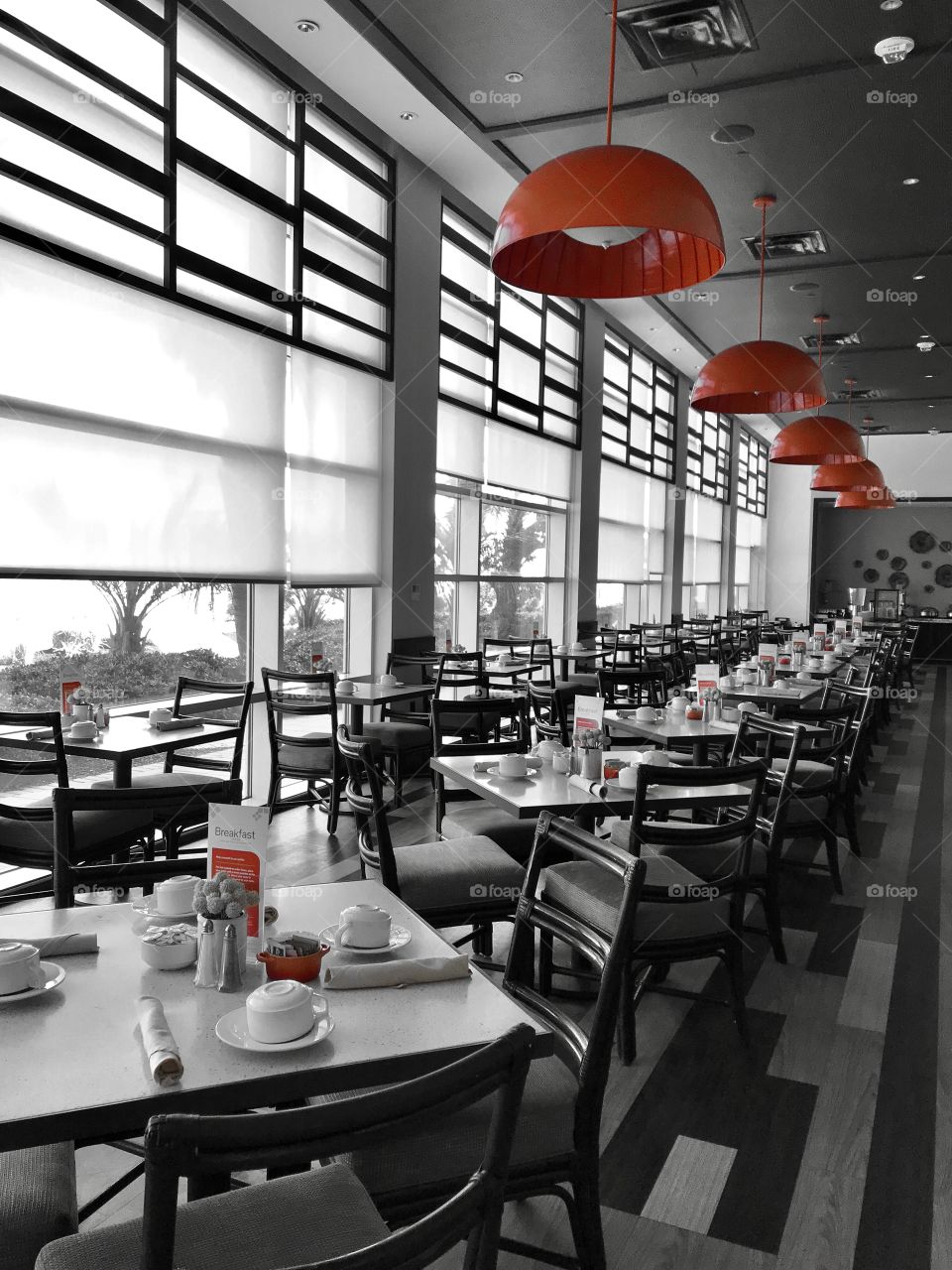 Hotel dining room with vibrant ceiling lamps 