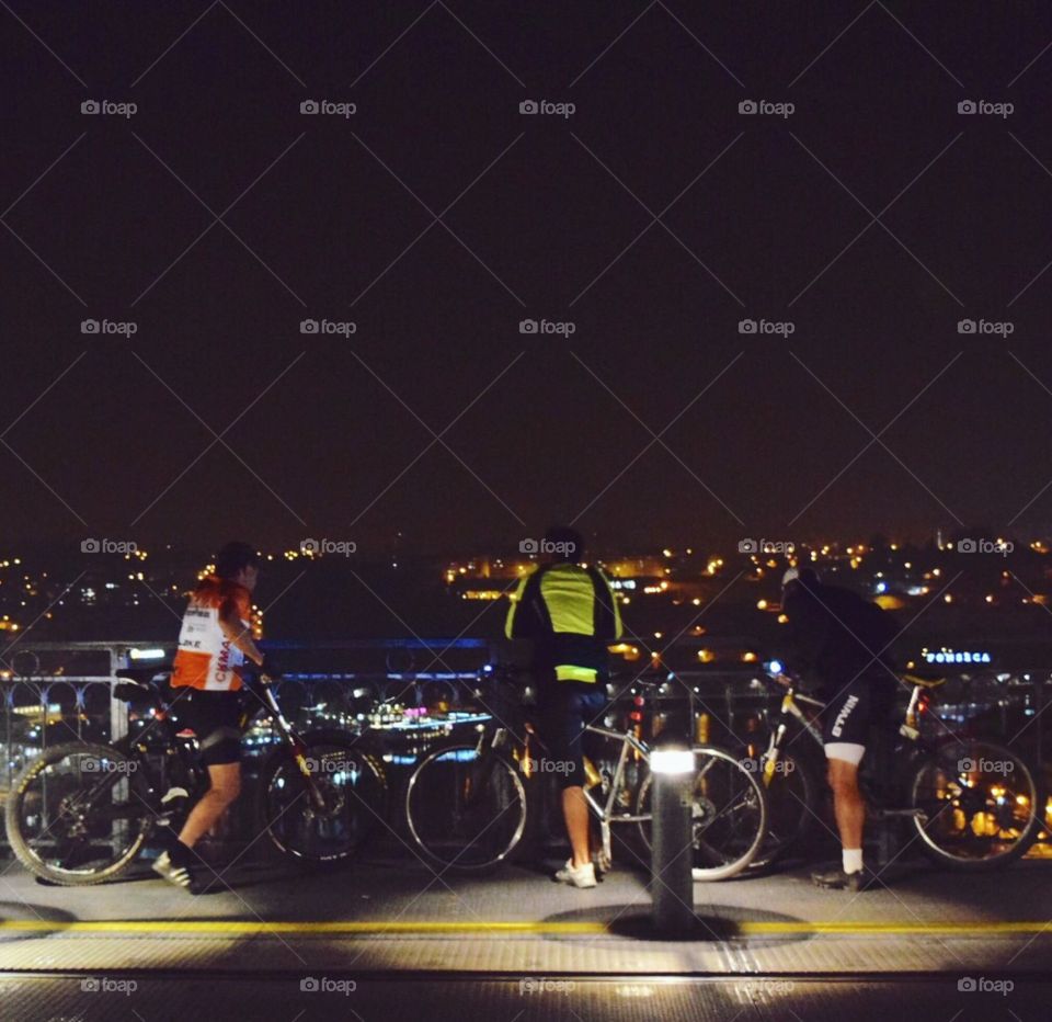 Cyclists looking down the bridge 