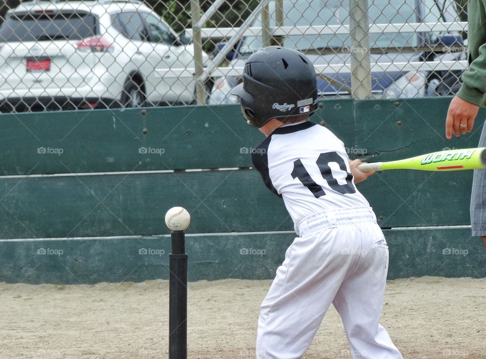 Young Baseball Player. Young Boy Taking A Swing In Youth Baseball
