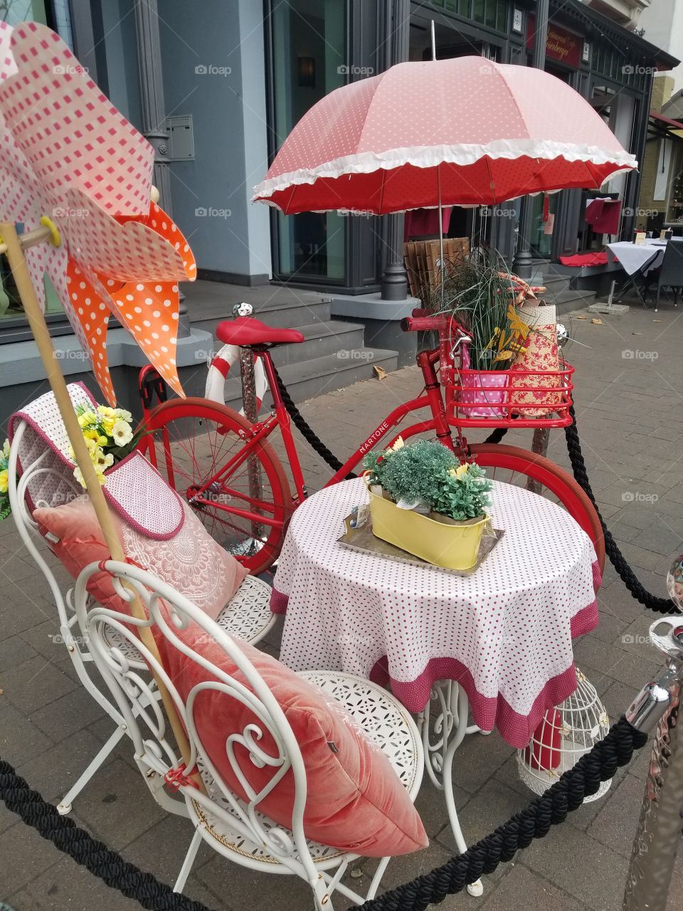 red bicycle and cafe table