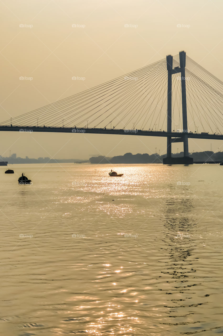 View of second Hooghly Bridge Kolkata India taken at dusk, at dawn, at daytime in landscape style. The Subject of the image is, inspiration, exciting, hopeful, bright, sensational, tranquil, calm, stunning may used as a background wallpaper screen sa