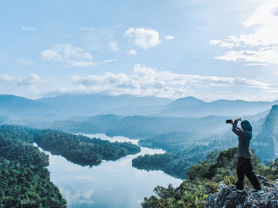 Taking selfie above the rainforest lake