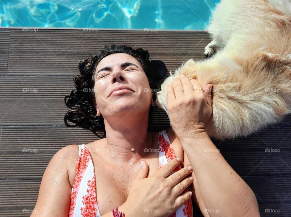 Dog licking a woman's ear