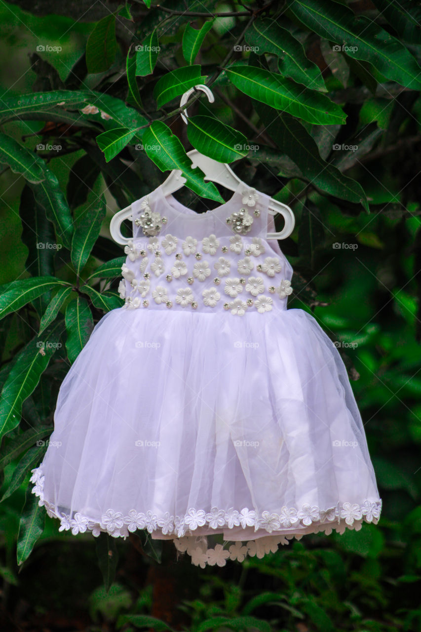 white colour girl baby dresses in green colour background #images of white colour girl baby frocks #party wear baby dresses # images of baptism dresses