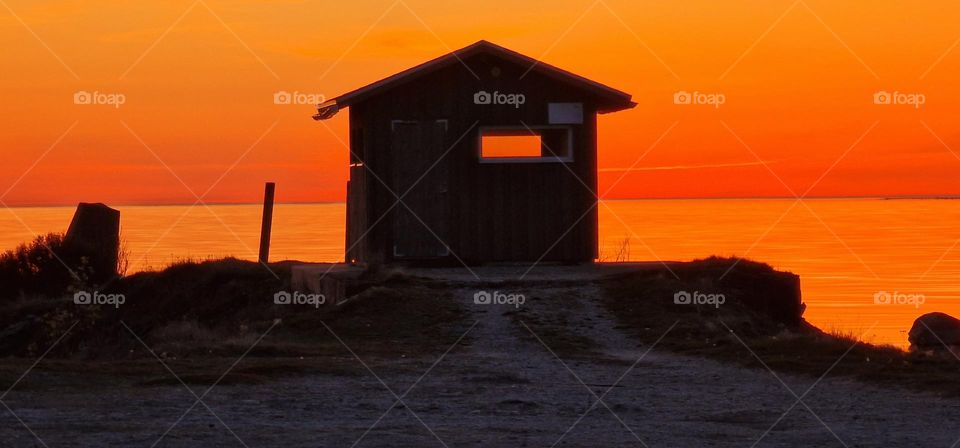 Cabin by the Baltic sea at sunset time in Western Estonia.
