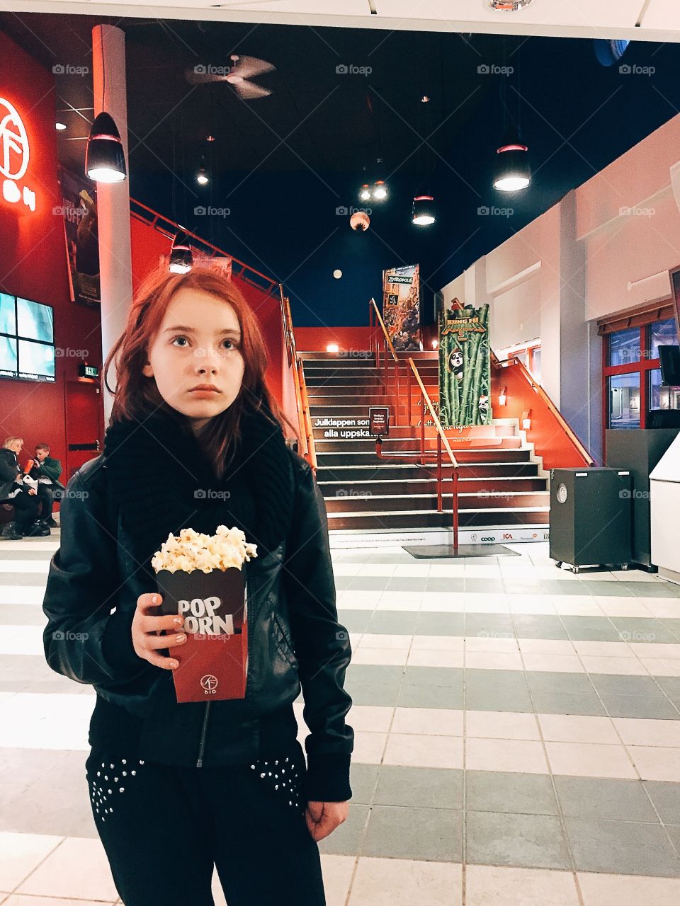 Girl holding popcorn at the movies