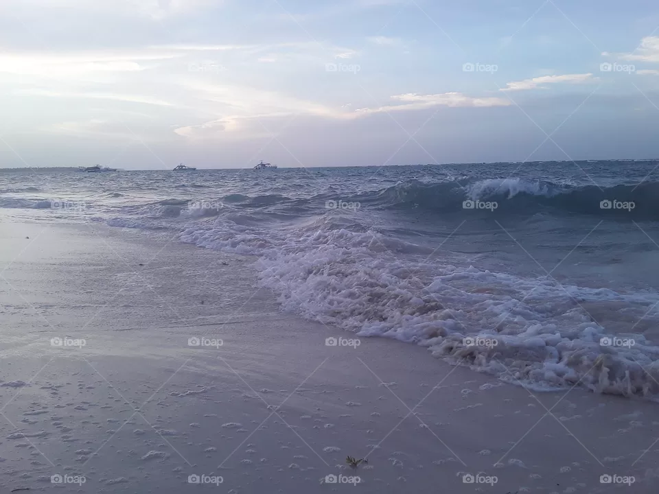 gentle colors of the evening ocean and soft light of the setting sun create a wonderful mood
