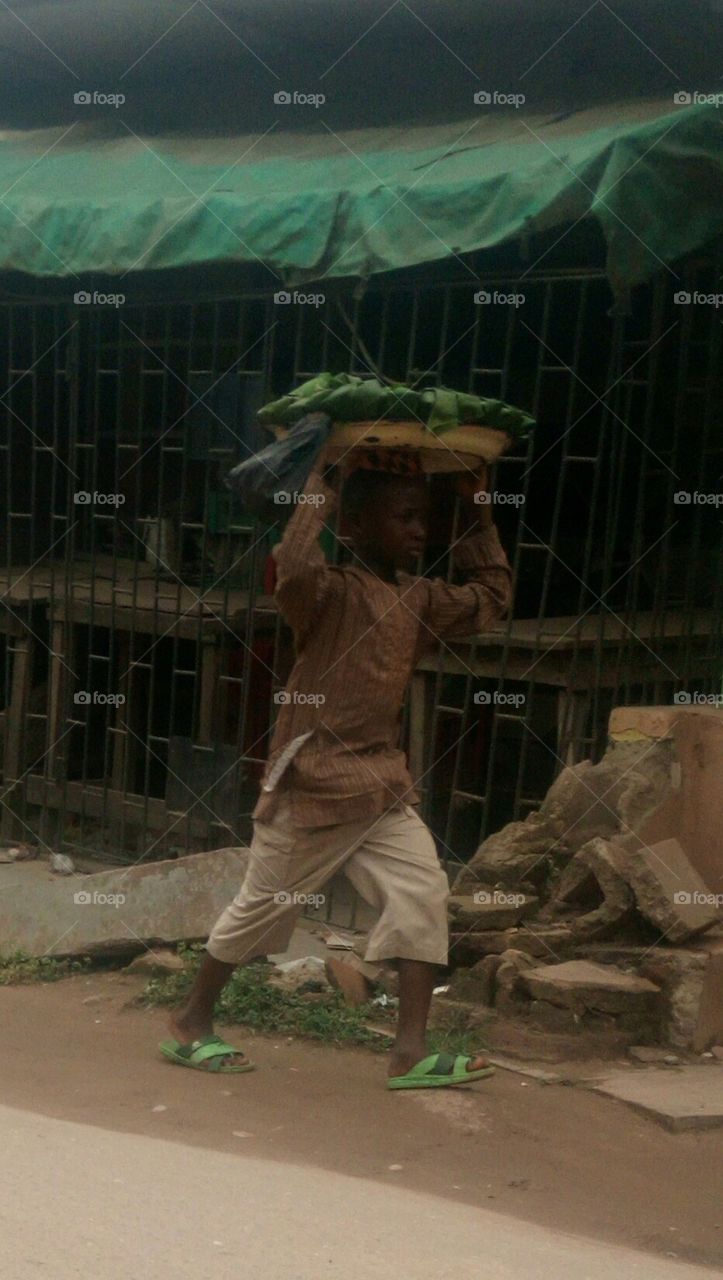 a child hawking on the street Lagos Nigeria