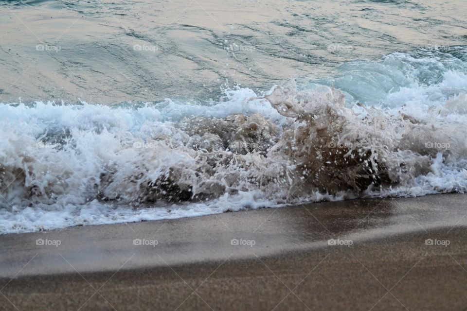 wave rolling up on the beach