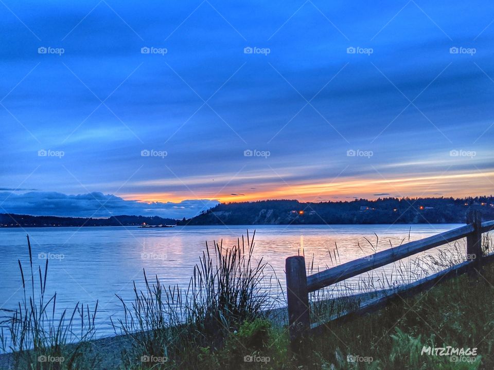 Capturing the beautiful blue hour over looking the calm water.