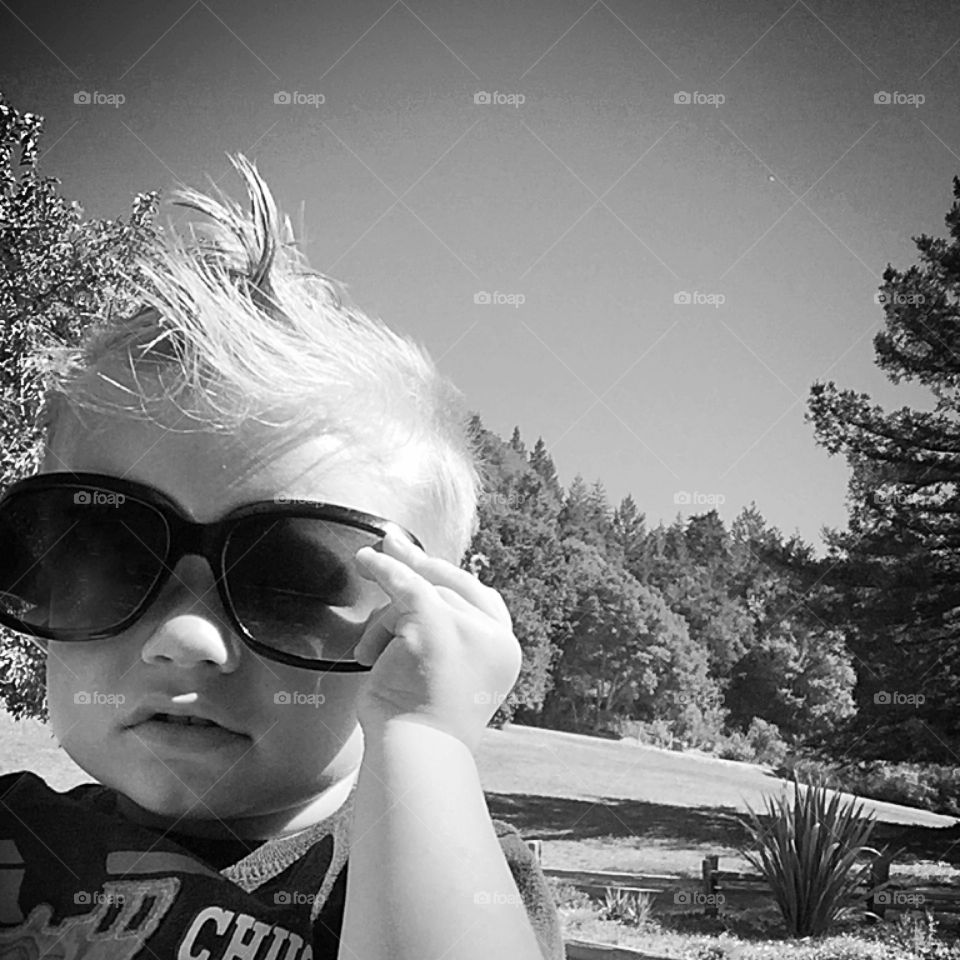 Baby holding sunglasses
