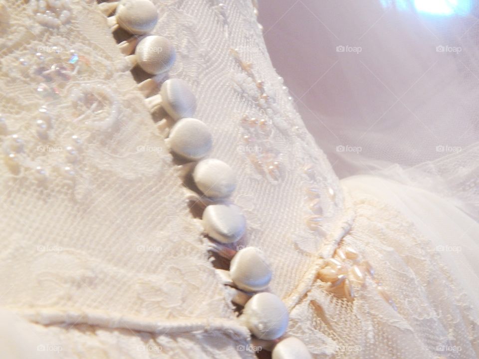 A close up of  a Victorian styled wedding dress 