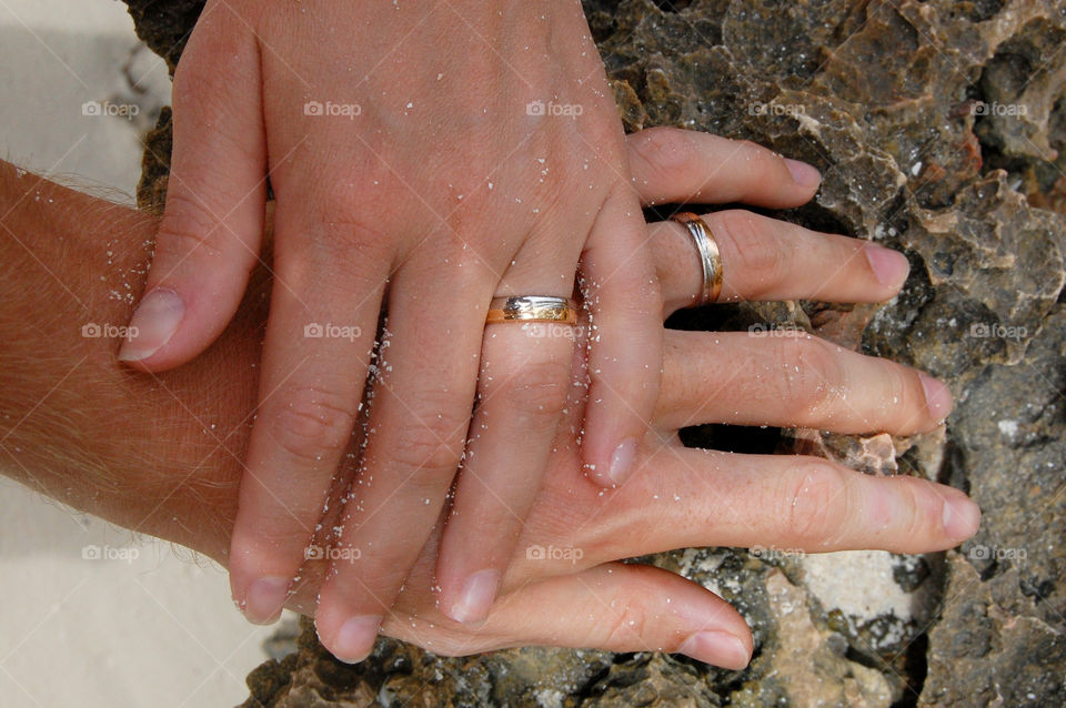 an engaged couple showing their rings together
