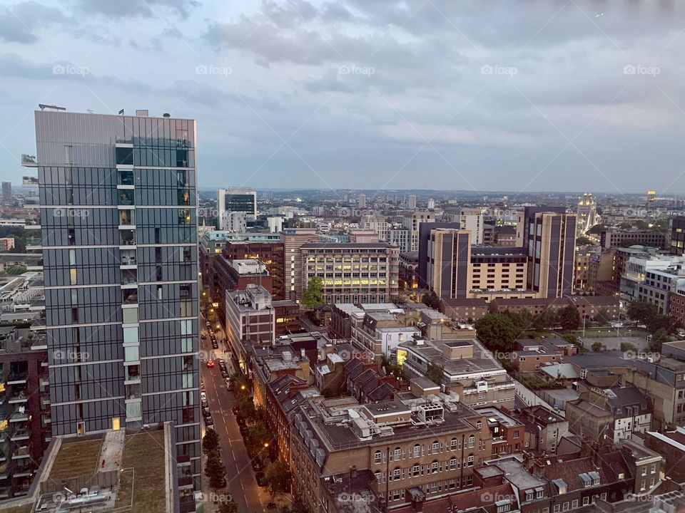 View of Aldgate quarter in London, shortly after sunset, building and skyscrapers 